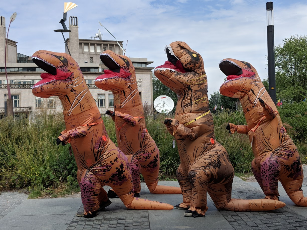 people wearing dinosaur suits